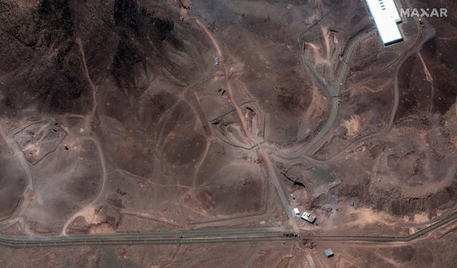 Several additional vehicles are also seen below a ridge and are parked along the path that was built to access the nuclear site, according to Maxar.