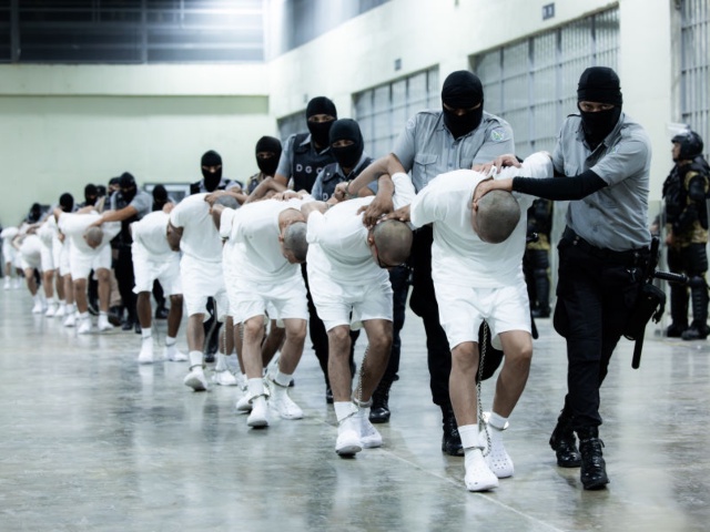 TECOLUCA, EL SALVADOR - MARCH 16: In this handout photo provided by the Salvadoran government, guards escort the inmates allegedly linked to criminal organizations at CECOT on March 16, 2025 in Tecoluca, El Salvador. Trump's administration deported 238 alleged members of the Venezuelan criminal organizations 'Tren De Aragua' and Mara Salvatrucha with only 23 being members of the Mara. Nayib Bukele president of El Salvador announced that his government will receive the alleged members of the gang to be taken to CECOT. On February of 2023 El Salvador inaugurated Latin America's largest prison as part of President Nayib Bukele's plan to fight gangs. (Photo by Salvadoran Government via Getty Images)