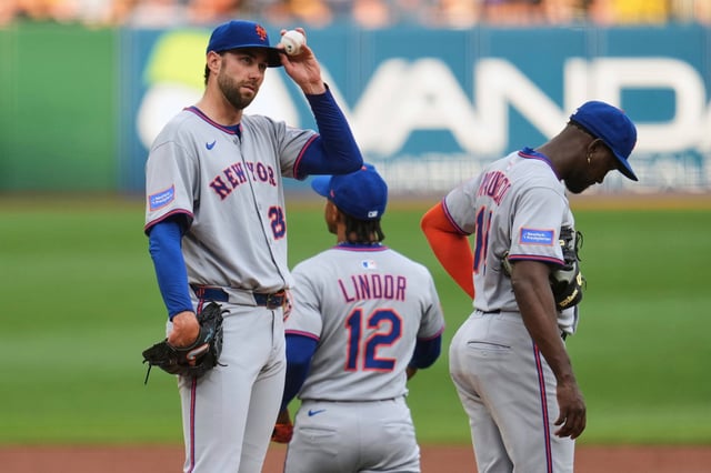 New York Mets pitcher David Peterson, left, collects himself after a visit from pitching coach Jeremy Hefner during the second inning of a baseball game against the Pittsburgh Pirates in Pittsburgh, Friday, June 27, 2025. (AP Photo/Gene J. Puskar)