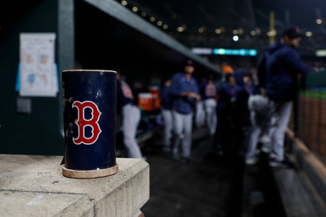 BALTIMORE, MARYLAND - SEPTEMBER 28: Detail view of a baseball bat weight with a Boston Red Sox logo against the Baltimore Orioles at Oriole Park at Camden Yards on September 28, 2023 in Baltimore, Maryland.