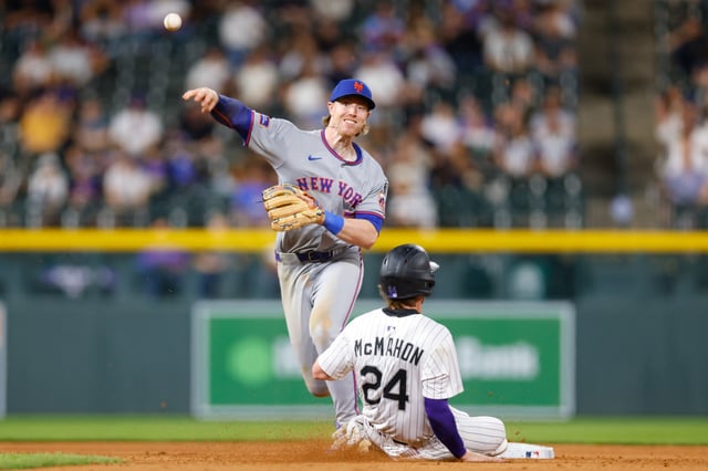 DENVER, CO - JUNE 7: Brett Baty #7 of the New York Mets throws to first base to complete the double play as Ryan McMahon #24 of the Colorado Rockies slides in in the eighth inning at Coors Field on June 7, 2025 in Denver, Colorado.