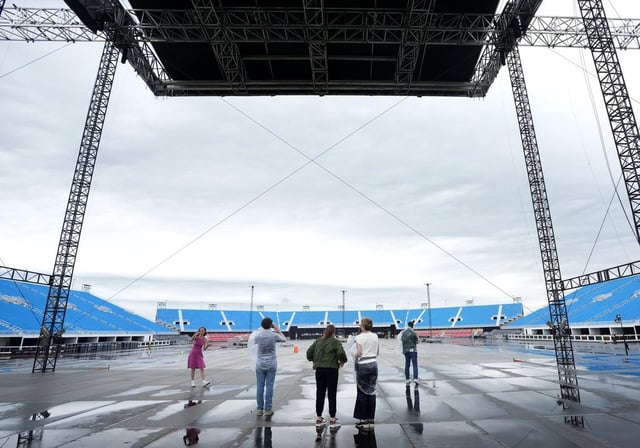 People stand on the stage at the brand new 50,000-seat concert venue, Rogers Stadium, in Toronto, Thursday, June 26, 2025. 