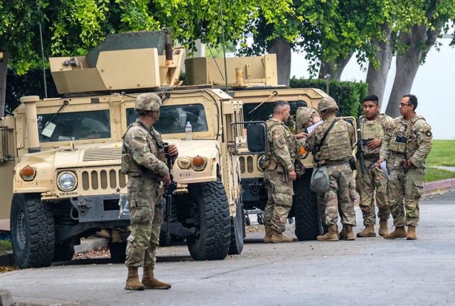 Members of the California National Guard gather at the entrance to the Paramount Business Center on Alondra Boulevard in Paramount, across the street from the Home Depot where day laborers gather to look for work, on Wednesday, June 11, 2025. (Photo by Mark Rightmire, Orange County Register/SCNG)