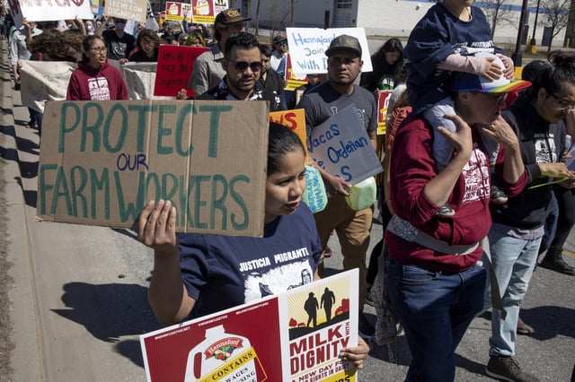 On May Day farm workers march to a Hannaford supermarket to protest the supermarket chain&#39;s refusal to purchase milk from dairy suppliers who have committed to a set of fair labor practices, May 1, 2022, in Burlington, Vermont.
