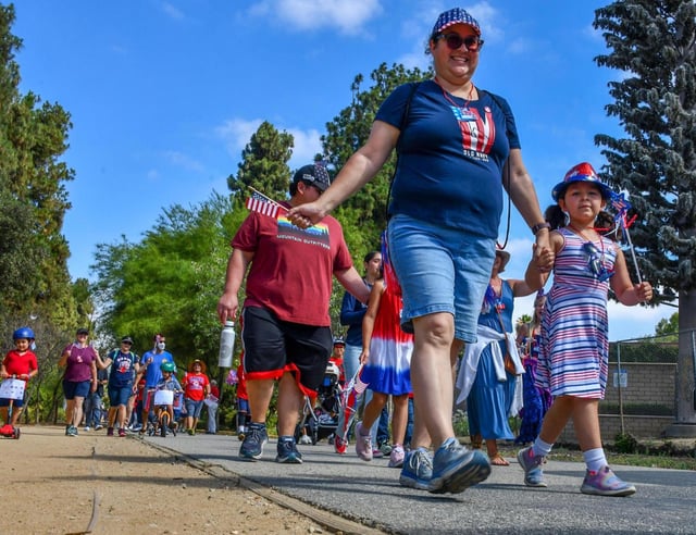 Participants join the Freedom Walk beginning at Palm Park on Monday July, 2022. The Freedom Walk begins at the Palm Park Trailhead and continues along the Greenway Trail. (Photo by Keith Durflinger, Contributing Photographer)