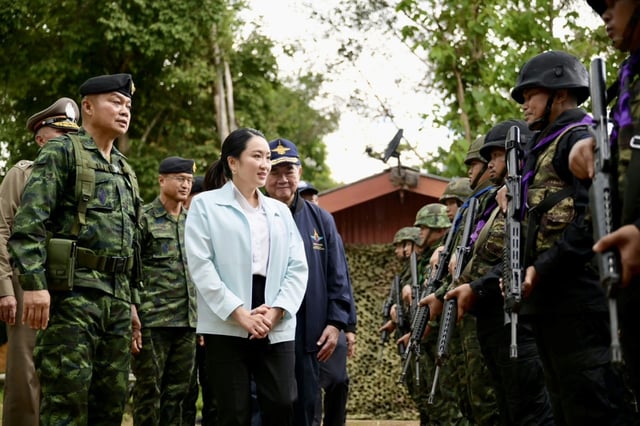 La Première ministre thaïlandaise Paetongtarn Shinawatra passe en revue les troupes dans la base militaire de Morakot, près de la frontière cambodgienne, en compagnie du général Boonsin Padklang (à gauche) le 20 juin 2025