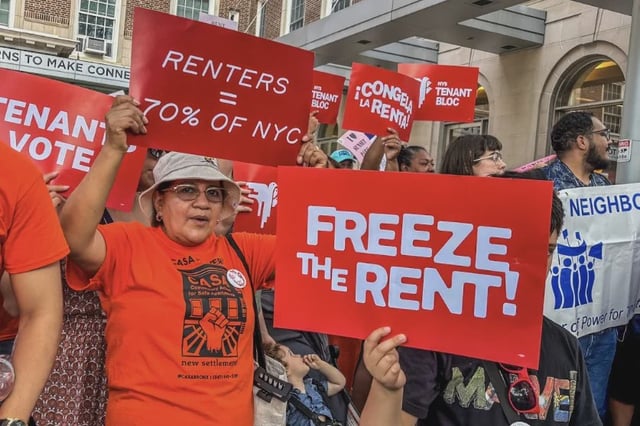 Tenants hold signs demanding a rent freeze outside the Rent Guidelines Board hearing in Manhattan.