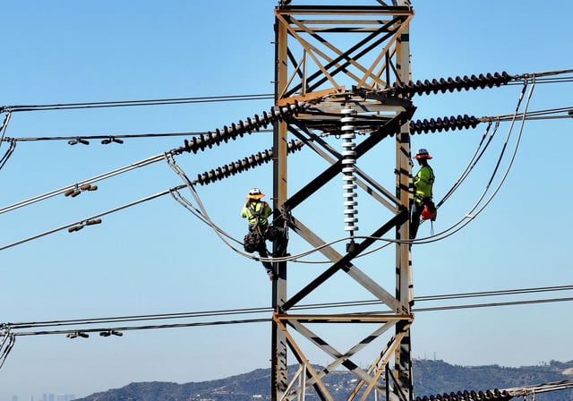 Inspectors climb transmission towers above Altadena and Pasadena, Calif., after the Eaton Fire on Thursday, March 20, 2025.