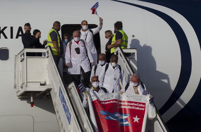 FILE - Cuban doctors arrive at the Jose Marti International Airport in Havana, Cuba, June 8, 2020, after traveling to Italy to help with the COVID-19 emergency response. (Ismael Francisco/Pool via AP, File)