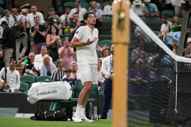 Taylor Fritz of the U.S. reacts after the first round men’s single match against Giovanni Mpetshi Perricard of France was suspended at the Wimbledon Tennis Championships in London, Monday, June 30, 2025. (AP Photo/Kin Cheung)