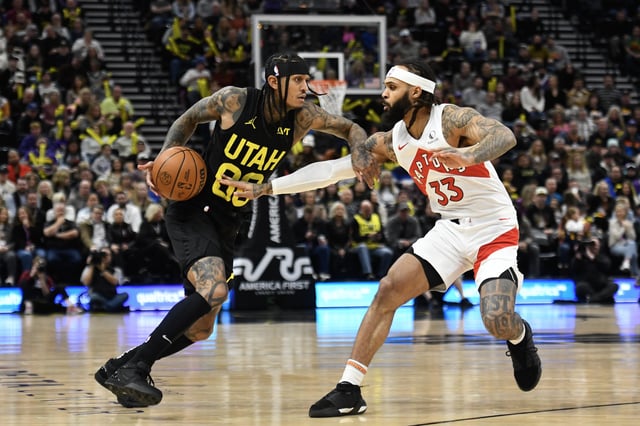 Jordan Clarkson #00 of the Utah Jazz drives into Gary Trent Jr. #33 of the Toronto Raptors during the first half of a game at Delta Center on January 12, 2024 in Salt Lake City, Utah.