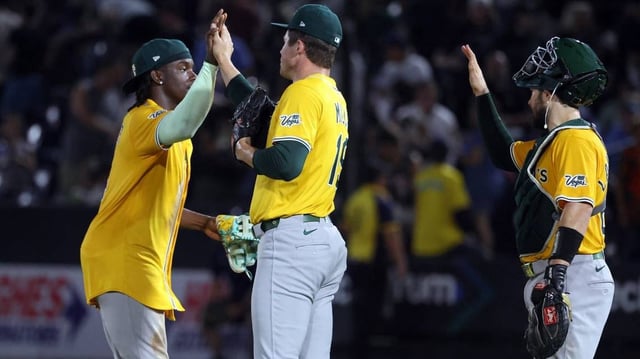 Jun 30, 2025; Tampa, Florida, USA;  Athletics pitcher Mason Miller (19) and outfielder Lawrence Butler (4) celebrate after they beat the Tampa Bay Rays at George M. Steinbrenner Field. Mandatory Credit: Kim Klement Neitzel-Imagn Images