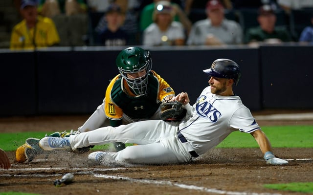 The Rays&#39; Brandon Lowe gets tagged out at home by the Athletics&#39; Shea Langeliers in the eighth inning in Tampa on Monday night.  (Photo by Mike Ehrmann/Getty Images)