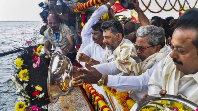 Chief Minister Siddaramaiah with Deputy Chief Minister D.K. Shivakumar offers the customary 'bagina' to the Cauvery river, at Krishnaraja Sagar (KRS) dam in Mandya district of Karnataka, on Monday (PTI)