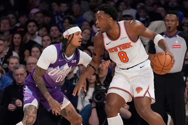 Utah Jazz&#39;s Jordan Clarkson (00) defends New York Knicks&#39; OG Anunoby (8) during the first half of an NBA basketball game Wednesday, Jan. 1, 2025, in New York. (AP Photo/Frank Franklin II)