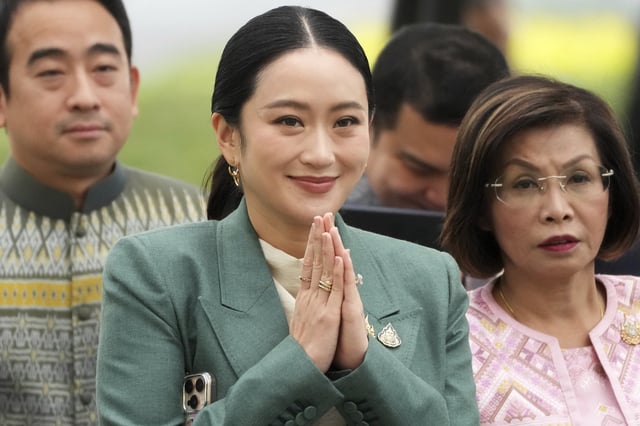 Thailand's Prime Minister Paetongtarn Shinawatra, center, arrives at Government House for a cabinet meeting in Bangkok, Thailand, Tuesday, July 1, 2025. (AP Photo/Sakchai Lalit)
