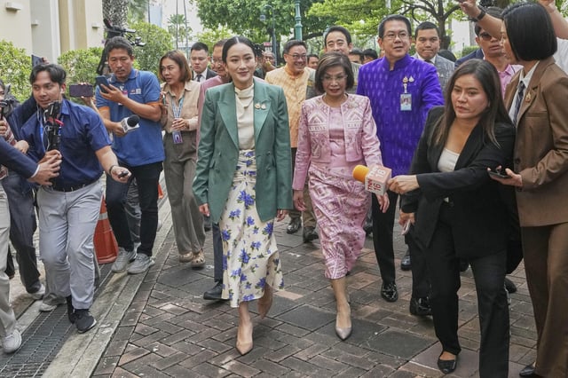 Thailand's Prime Minister Paetongtarn Shinawatra, center, arrives at Government House for a cabinet meeting in Bangkok, Thailand, Tuesday, July 1, 2025. (AP Photo/Sakchai Lalit)