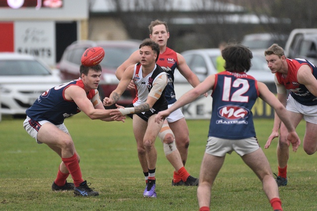 Josh Werchon passes the ball out of the pack during a solid showing for the Saints on Saturday. (James Murphy: 487684)