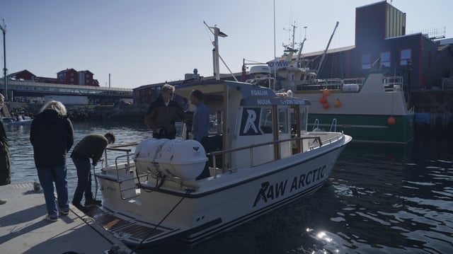 Passengers and tour guide on a tour boat of Raw Arctic at a harbour in Nuuk, Greenland, Wednesday, June 18, 2025. (AP Photo/Kwiyeon Ha)