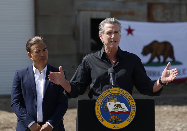 California Governor Gavin Newsom (R) speaks as California Attorney general Rob Bonta looks on during a news conference at Gemperle Orchard on April 16, 2025, in Ceres, California.