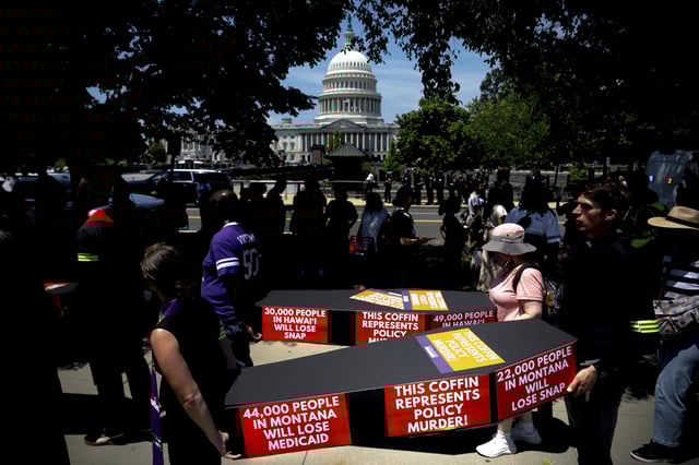 Demonstrators carry cardboard caskets in front of the U.S. Capitol in protest of President Donald Trump's tax breaks and spending cuts package, Monday, June 30, 2025, in Washington. (AP Photo/Julia Demaree Nikhinson)