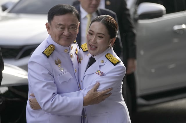 FILE - Thailand's former Prime Minister Thaksin Shinawatra, left, hugs his daughter and newly elected Prime Minister Paetongtarn Shinawatra before the royal endorsement ceremony appointing Paetongtarn as Thailand's new prime minister at Pheu Thai party headquarters in Bangkok, Thailand, on Aug. 18, 2024. (AP Photo/Sakchai Lalit, File)