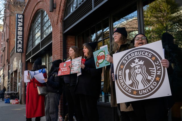 Starbucks workers strike outside a Starbucks coffee shop on November 17, 2022 in the Brooklyn borough of New York City.