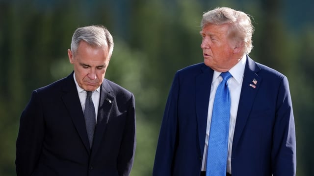 Prime Minister Mark Carney, left, listens to U.S. President Donald Trump while posing for a photograph during the G7 Summit in Kananaskis, Alta., on June 16. 