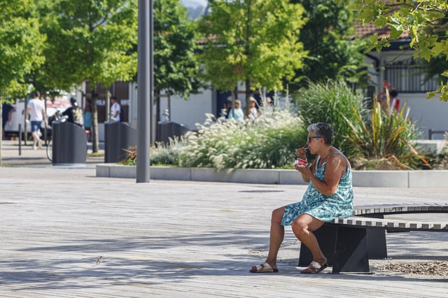A woman eats an ice cream, Monday, June 30, 2025 in Saint-Jean-de-Luz, southwestern France. (AP Photo/Nicolas Mollo)