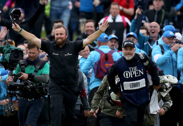 PORTRUSH, NORTHERN IRELAND - JULY 21: Shane Lowry of Ireland breaks through the huge crowds on the 18th hole and celebrates with his caddie Brian Martin on his way to completing his victory during the final round of the 148th Open Championship held on the Dunluce Links at Royal Portrush Golf Club on July 21, 2019 in Portrush, United Kingdom. (Photo by David Cannon/Getty Images)