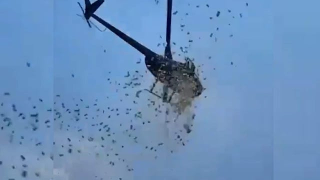 A helicopter dropped $5,000 at a Detroit man's funeral.