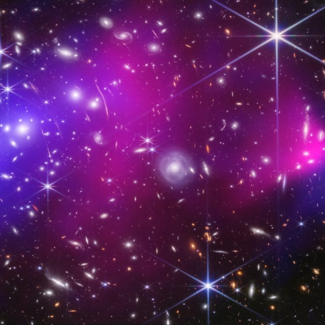 By merging data from NASA's Chandra X-ray Observatory with new infrared data from the James Webb Space Telescope, scientists have unprecedented detail into the Bullet Cluster. The blue represents the dark matter.