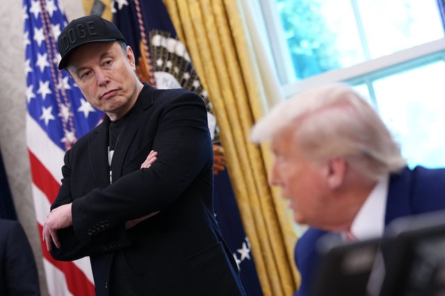  Elon Musk listens as President Donald Trump speaks to reporters in the Oval Office of the White House.