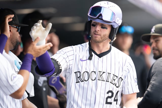 DENVER, COLORADO - JULY 24: Ryan McMahon #24 of the Colorado Rockies celebrates with his bench after hitting a home run against the Boston Red Sox at Coors Field on July 24, 2024 in Denver Colorado.
