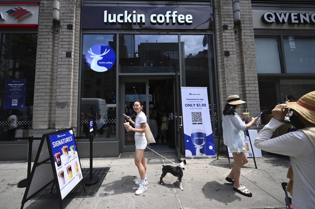 People stand outside of &#39;Luckin Coffee&#39; store on opening day of one of two U.S. locations in Manhattan, New York, NY, June 30, 2025.
