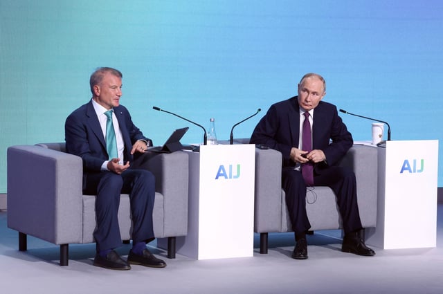 Russia&#39;s President Vladimir Putin (R) and Russian Sberbank CEO German Gref attend Sberbank conference on artificial intelligence in Moscow on December 11, 2024.