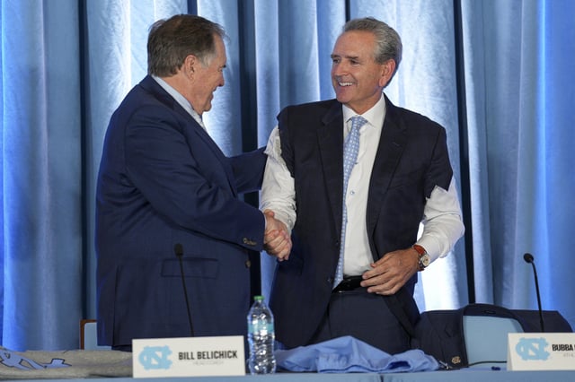 Dec 12, 2024; Chapel Hill, NC, USA;  North Carolina Tar Heels new head coach Bill Belichick shares a moment with athletic director Bubba Cunningham at Loudermilk Center for Excellence. Mandatory Credit: Jim Dedmon-Imagn Images/File Photo