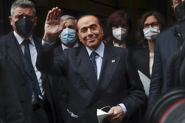 FILE - Former Italian Premier Silvio Berlusconi waves to reporters as he arrives at the Chamber of Deputies to meet Mario Draghi, in Rome, Feb. 9, 2021. Berlusconi is a Serie A owner again after his Monza club won a Serie B playoff Sunday to reach the top division. (AP Photo/Alessandra Tarantino, File)