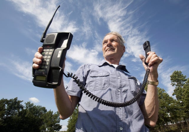 Victor Surerus poses for a photo at his farm in Roseneath, Ontario, on Wednesday, June 24, 2015 with the first cellphone in Canada. 