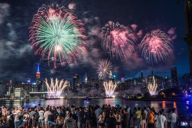 Spectators gather along Williamsburg&#39;s waterfront in Brooklyn for the Macy&#39;s fireworks display with a view of Manhattan&#39;s skyline, as fireworks explode from barges on the East River to celebrate Independence Day on Monday July 4, 2022, in New York. (Bebeto Matthews / AP)