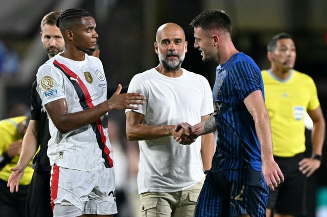 Manchester City coach Pep Guardiola with Al-Hilal's Sergej Milinkovic-Savic (R) following Monday's Club World Cup game in Orlando