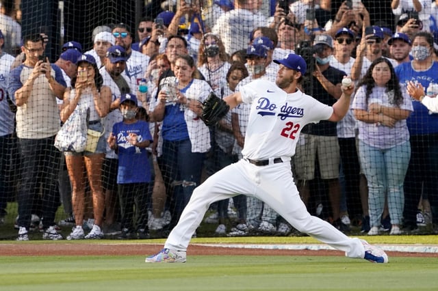 Dodgers pitcher Clayton Kershaw, warming gup in front of fans in the Dodger Stadium Centerfield Plaza area prior to a game in 2021, could go down as just the third member of the 3,000-strikeout club to pitch for just one team. (AP Photo/Mark J. Terrill)