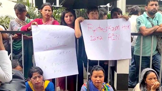 Hawkers hold up placards in Shillong.