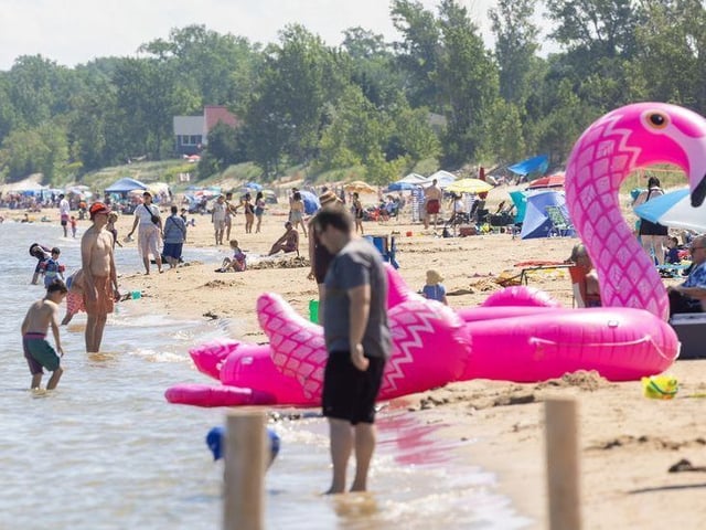 Umbrellas line Ipperwash Beach as families celebrate Canada Day on the shores of Lake Huron on Tuesday, July 1, 2025, a day after an 18-year-old from London drowned at the beach and a 12-year-old from London was rescued by bystanders. (Mike Hensen/The London Free Press)