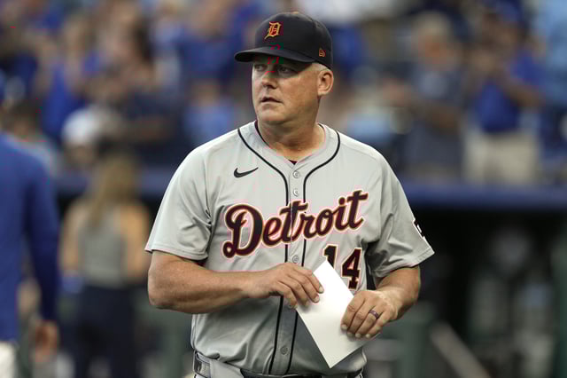 KANSAS CITY, MISSOURI - SEPTEMBER 16: Manager A.J. Hinch #14 of the Detroit Tigers walks back to the dugout after delivering the starting lineup prior to a game against the Kansas City Royals at Kauffman Stadium on September 16, 2024 in Kansas City, Missouri.