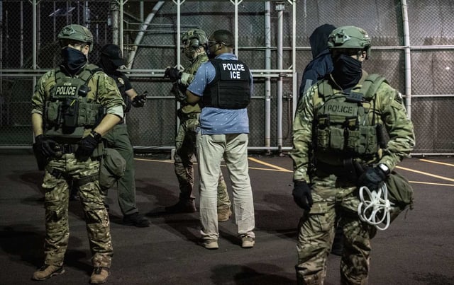 Immigration and Customs Enforcement (ICE) agents guard outside Delaney Hall, a migrant detention facility in Newark, New Jersey.