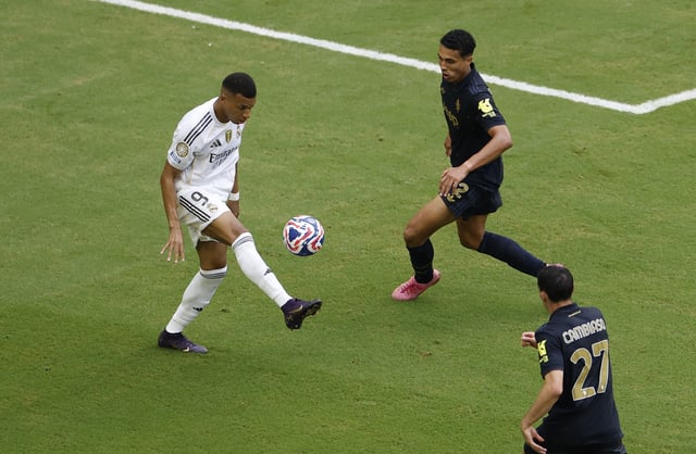 Soccer Football - FIFA Club World Cup - Round of 16 - Real Madrid v Juventus - Hard Rock Stadium, Miami Gardens, Florida, U.S. - July 1, 2025 Real Madrid's Kylian Mbappe in action with Juventus' Alberto Costa REUTERS/Marco Bello