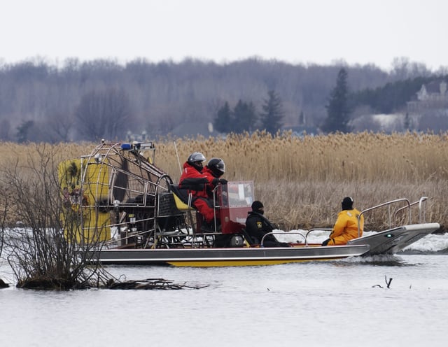 Searchers look for victims Friday, March 31, 2023 after a boat capsized and left six people dead and one infant missing in Akwesasne, Que. THE CANADIAN PRESS/Ryan Remiorz
