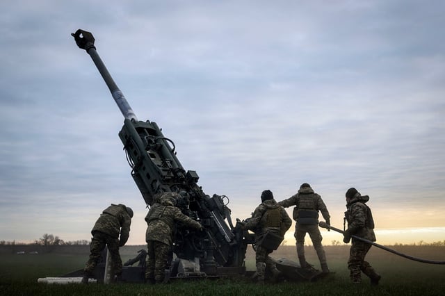 Ukrainian soldiers prepare a U.S.-supplied M777 howitzer to fire at Russian positions in Kherson region, Ukraine, on Jan. 9, 2023. 