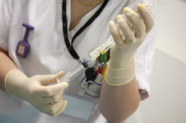 Stock photo of nurse preparing an injection in a pediatric center.